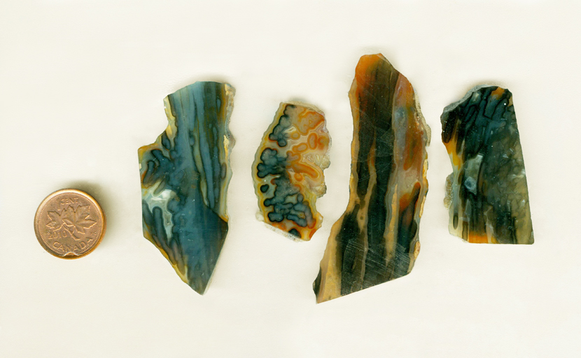 Four slabs of stalactite agate, orange blue and yellow patterns.