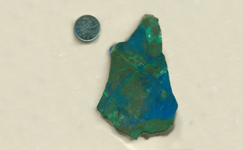 Bright green, blue and reddish-brown colors, patterned in large and small shapes - all in a slab of Burnite from Nevada.