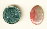 Cabochon of bright pink Myrickite, with two shades of pink, one on either side of the stone. 