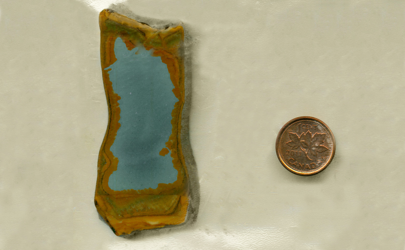 A slab of Owyhee Picture Jasper from Idaho, with a blue sky in the center and a bright brown rim.
