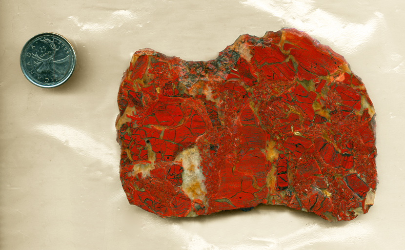 Slab of red patterned Brecciated Jasper from Africa, with each gap filled in with white and colorless chalcedony.