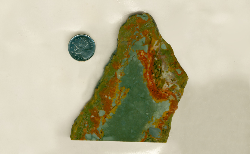 A slab of landscape Rocky Butte Jasper from Oregon, with greenish-blue, orangey-red and green bright layers.