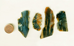 Four slabs of stalactite agate, orange blue and yellow patterns.