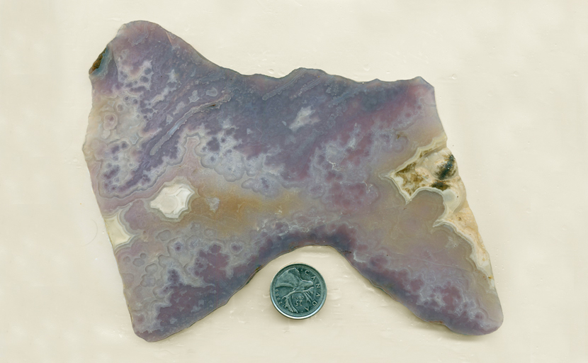 Bow-shaped slab of purple Royal Aztec Agate from Mexico, with lace and fortification patterns.