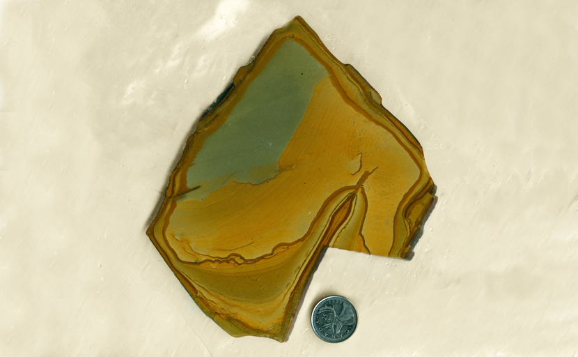 Slab of Wild Horse Picture Jasper from Idaho, with a blue-green sky and yellow-orange hillside shape.