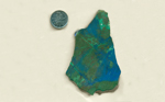 Bright green, blue and reddish-brown colors, patterned in large and small shapes - all in a slab of Burnite from Nevada.