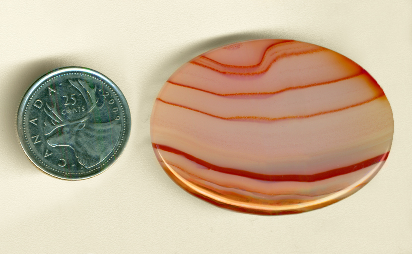 Large oval scarlet, pink and yellow striped Brazilian Agate cabochon.