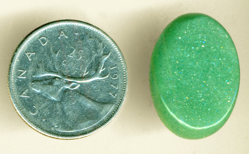 Shimmering green Aventurine cabochon from India, with refractive, multi-color sparkles.