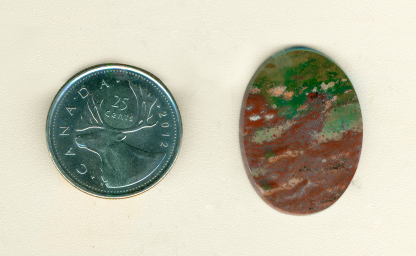 Calibrated polished Fancy Jasper cabochon from India, part green and part burgundy, with flecks of gold and sea-blue.