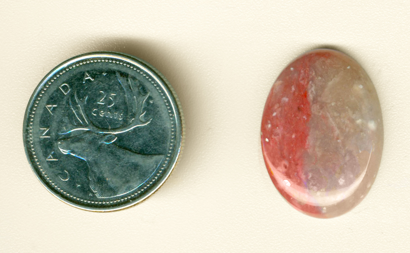 Cabochon of bright pink Myrickite, with two shades of pink, one on either side of the stone. 