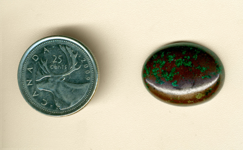 Bright blue Malachite flecks on a brown Cuprite background, producing a cabochon of Arizona Cuprite and Malachite.