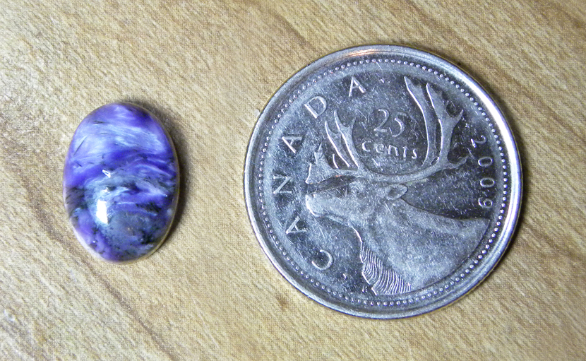 Purple, swirling, lustrous cabochon of Charoite from Siberia.