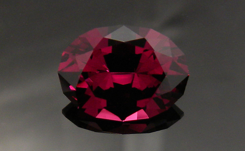Oval faceted Rhodolite Garnet from Tanga, Tanzania, bright and strong strawberry red.