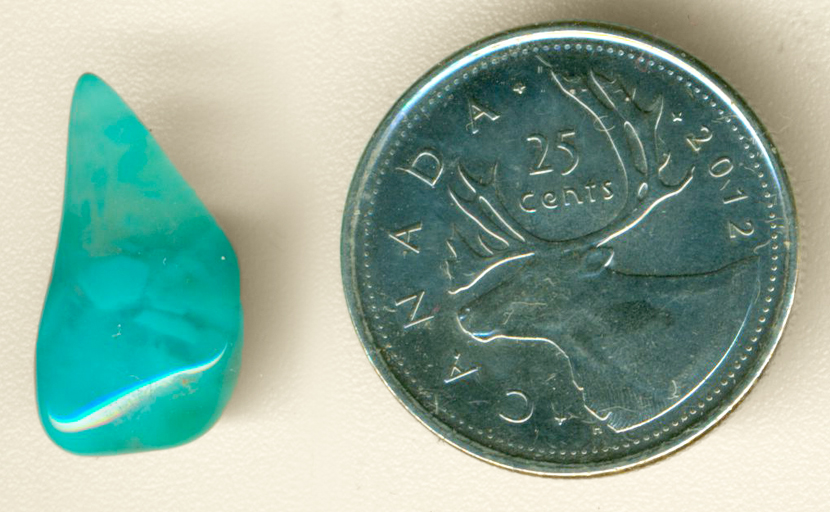 Cool-blue polished freeform Chrysocolla-in-Chalcedony from the Inspiration Mine in Globe County, Arizona, with lighter shapes floating in the bright mass.