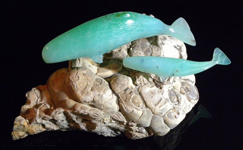 Carving of sperm whale mother and calf, carved out of bright greenish-blue Chrysoprase, attached to a base of Petrified Algae with quartz dowels.