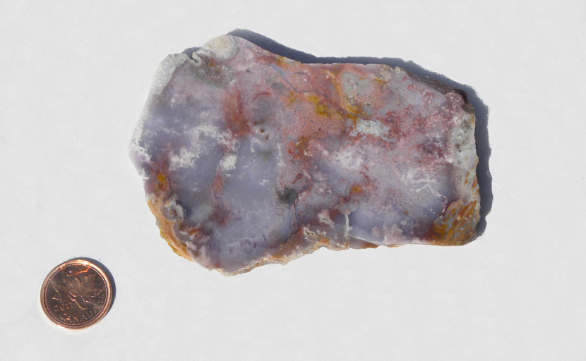 Purple Swirl Agate slab with red and yellow colors spread across the purple surface.