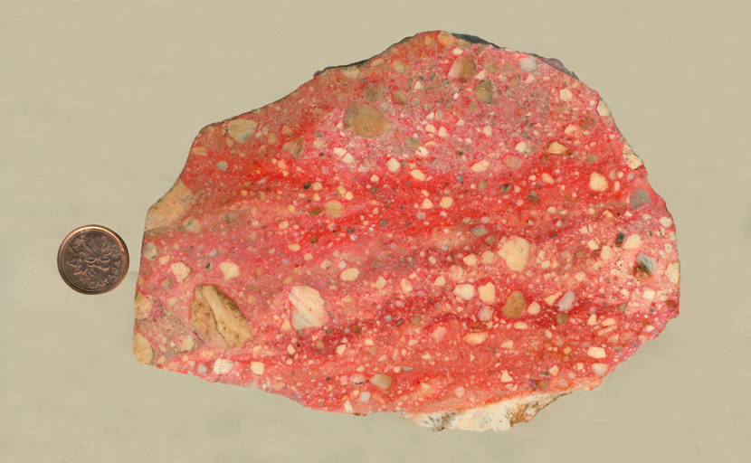 A slab of Cinnabar Opal (Myrickite) from Nevada or Washington, with various shapes on a background of bright pink.