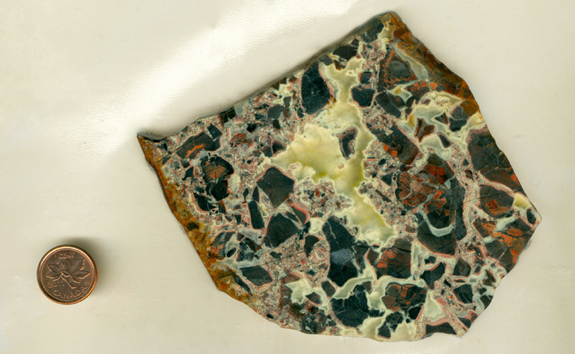 A slab of Brecciated Jasper from Africa, with black and red jasper broken up and the cracks filled in with clear chalcedony. 