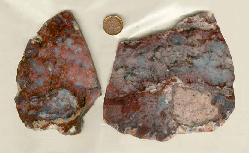Two slabs of Jasper from India, with red, pink and purple web patterns on a background of blue, with highlights of white and yellow.