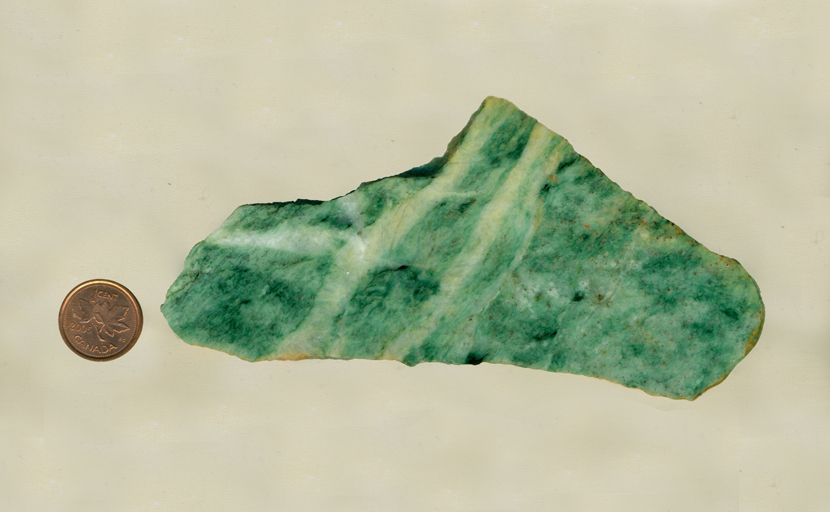 A vaguely triangular slab of mint green Mariposite from California.