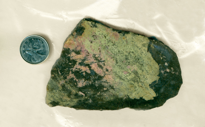 A slab from Colorado, with pink rhodonite and green epidote together on a black background.