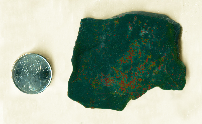 Slab of Bloodstone from India, with red-orange droplets splattered on a deep green surface.