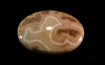 Calibrated polished Fairburn Agate cabochon from Nebraska or South Dakota, with brown and red patterns built around dark brown islands.