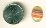 Orange and white striped cabochon of translucent agate from Uruguay.