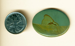Cabochon of Succor Creek Jasper from Washington, with a greenish-blue sky and a desert below it, patterned and with a central mountain.