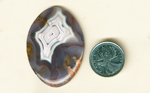 Purple, white, pink and yellow cabochon of Parcelas Agate from Mexico.