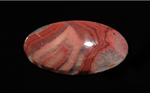 Calibrated oval polished Fairburn Agate from Nebraska or South Dakota, with concentric pink and red stripes suspended in clear chalcedony.