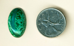 Bright green tubes and a blue line in a cabochon of Malachite in Gem Silica from the Inspiration Mine, Globe County, Arizona.