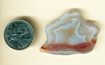 Irregularly shaped white and red Laguna Agate from Mexico, with white shell shapes and red river running underneath.