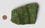 A slab of green Rice Copper Jasper from Mexico, spangled with lighter squares and patterned with rich brown lines, among which are shards of brighter green.