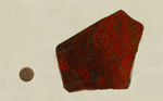 A slab of chalcedony, or flint, with bright red patches and spots overlaid on a dark dark red background.
